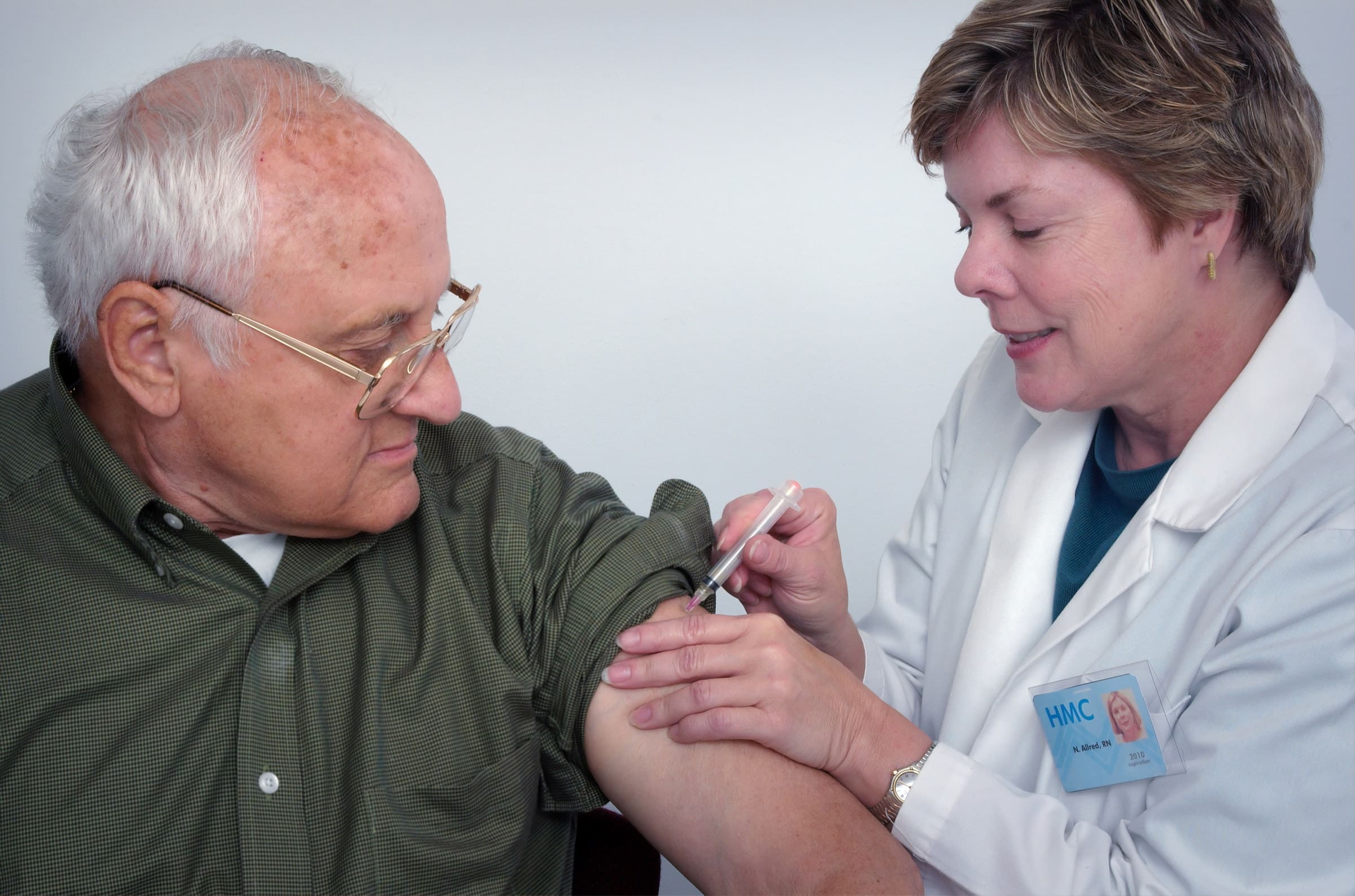 Representative photo of a home health care provider administering an injection to a senior citizen | Photo by CDC on Unsplash